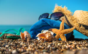 Accessories on the beach by the sea. Selective focus. Travel.